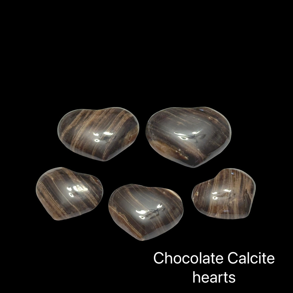 Five chocolate calcite hearts on a black background, front view.