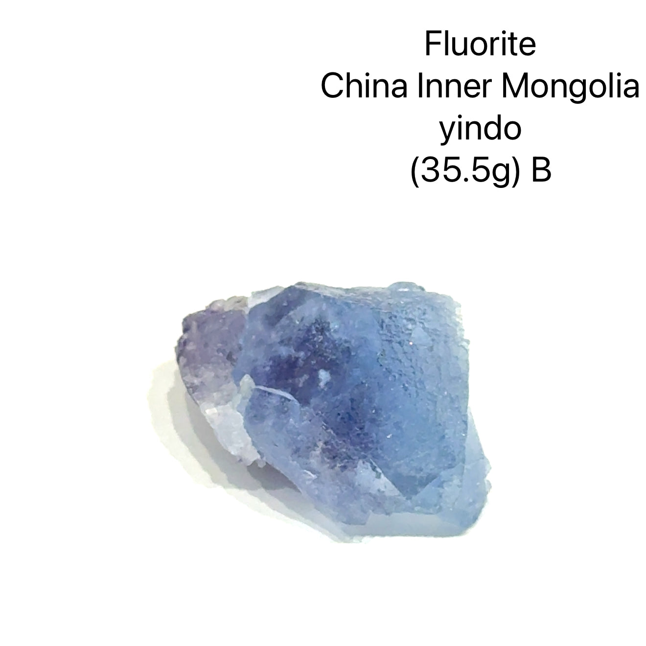 Fluorite crystal from China, Inner Mongolia, with weight and origin information on a white background, (35.5g) B front view. 
