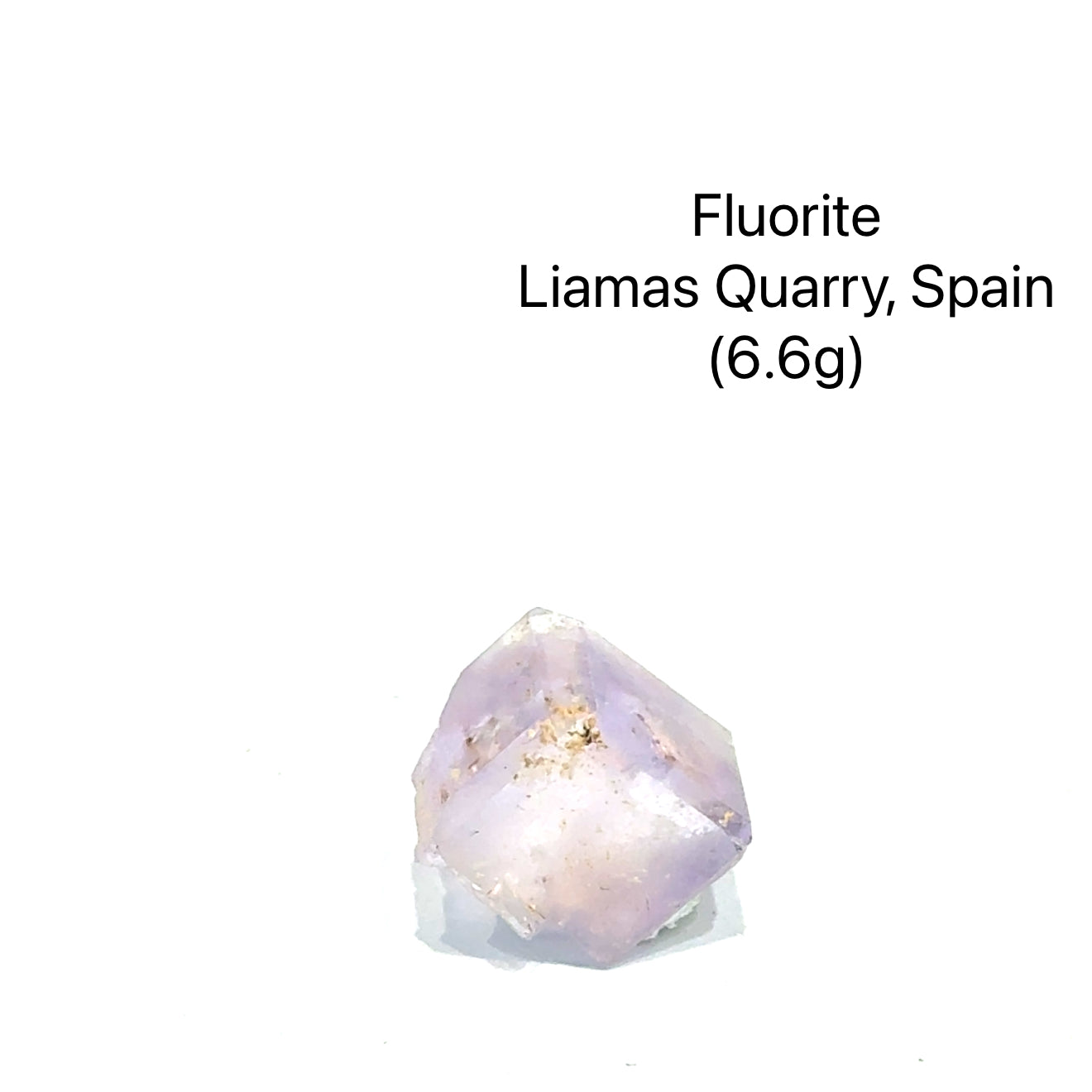 Fluorite crystal from Liamas Quarry, Spain, on a white background (6.6g), front view.