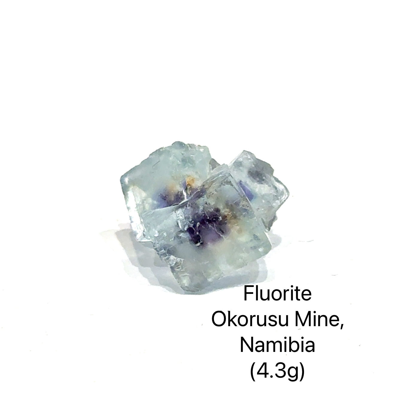 Fluorite crystal from Okorusu Mine, Namibia, on a white background (4.3g), front view.