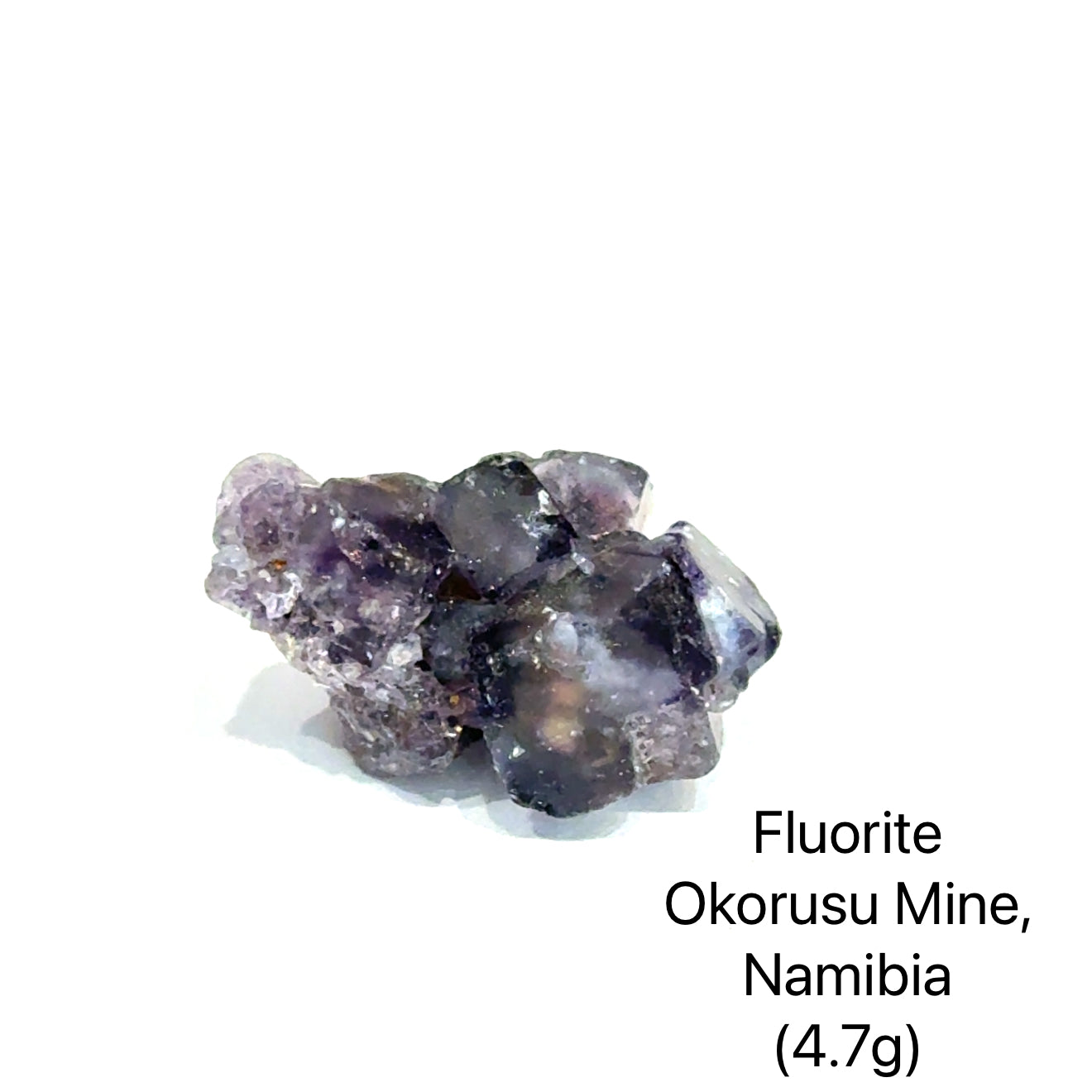Fluorite crystal from Okorusu Mine, Namibia, on a white background (4.7g), front view.