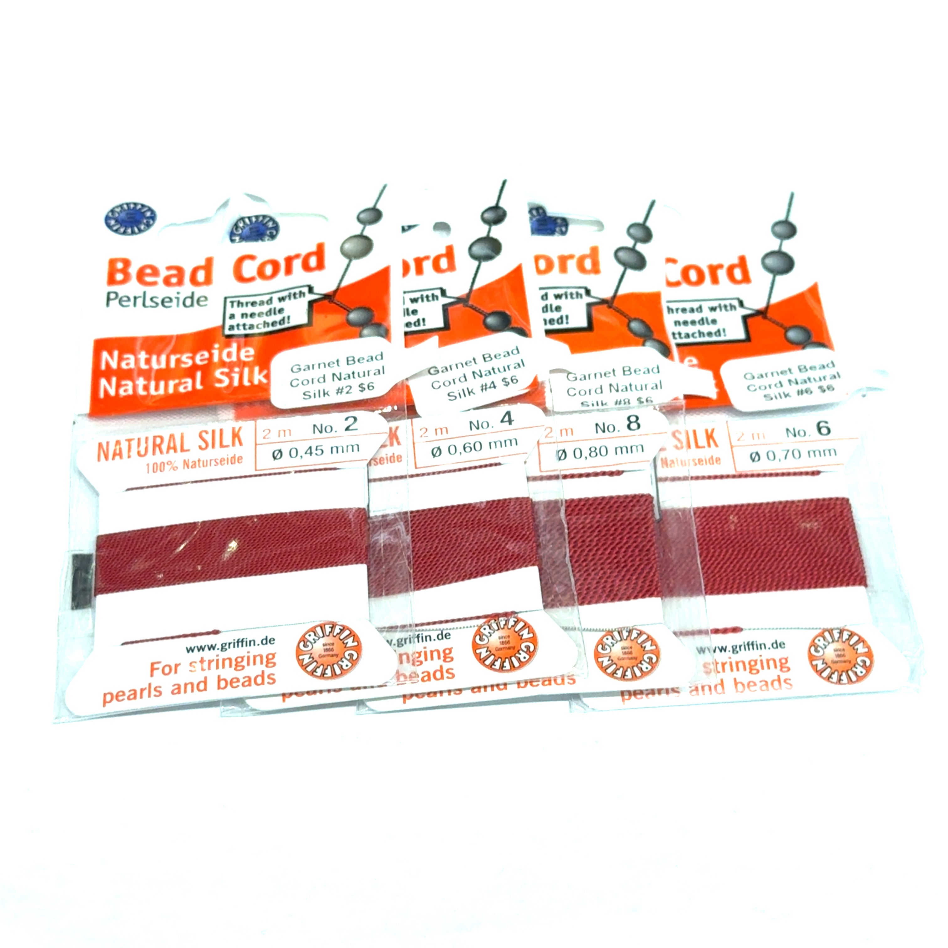 Four package of Garnet Natural Silk Bead Cord  #2,4, 6, & 8 on a white background, front view.