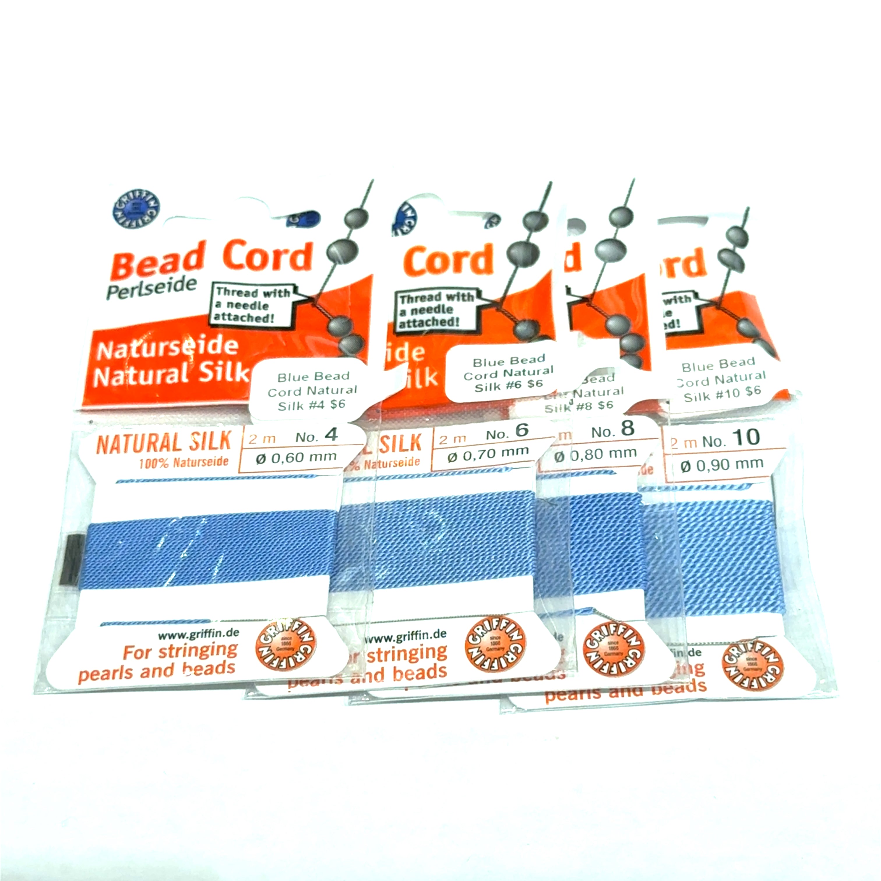 Four packages of Blue Natural Silk Bead Cord  #4, 6, 8, & 10 on a white background, front view.