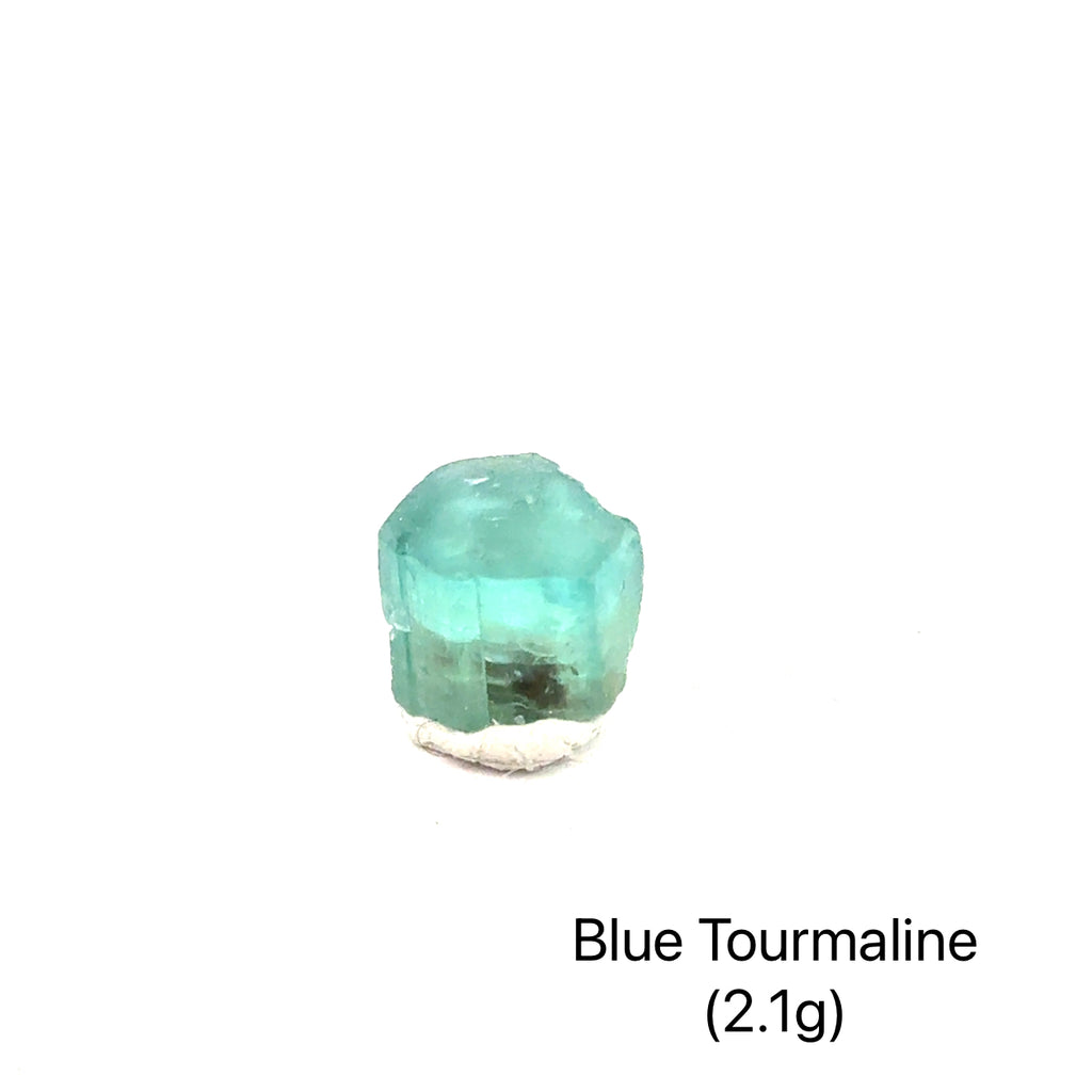 Genuine Blue Tourmaline Raw Gemstone on white 2.1g front view