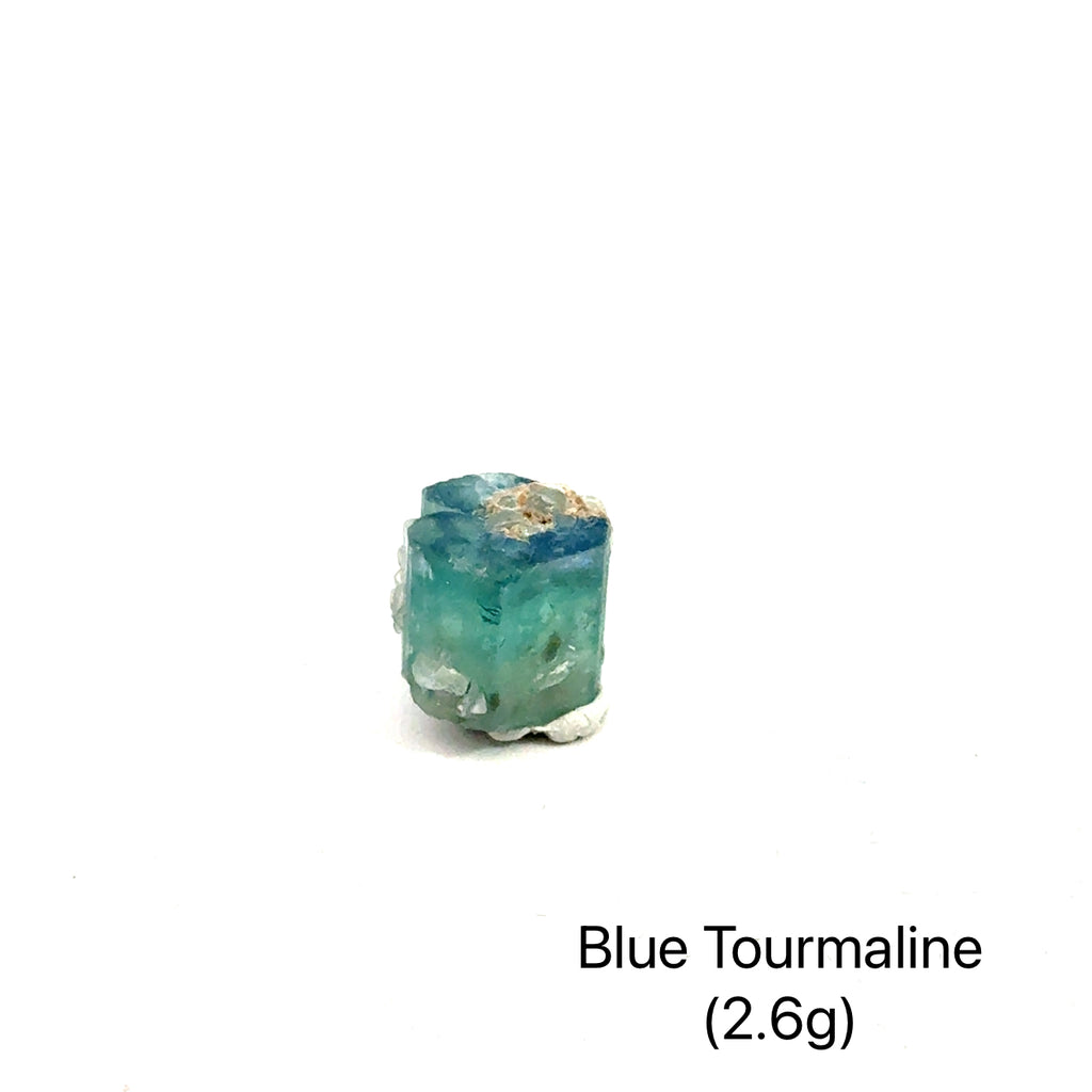Genuine Blue Tourmaline Raw Gemstone on white 2.6g front view