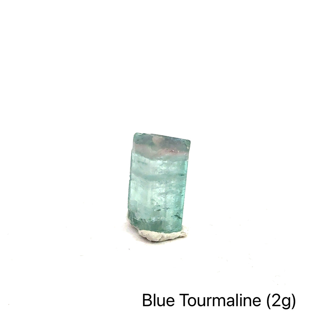 Genuine Blue Tourmaline Raw Gemstone on white 2g front view