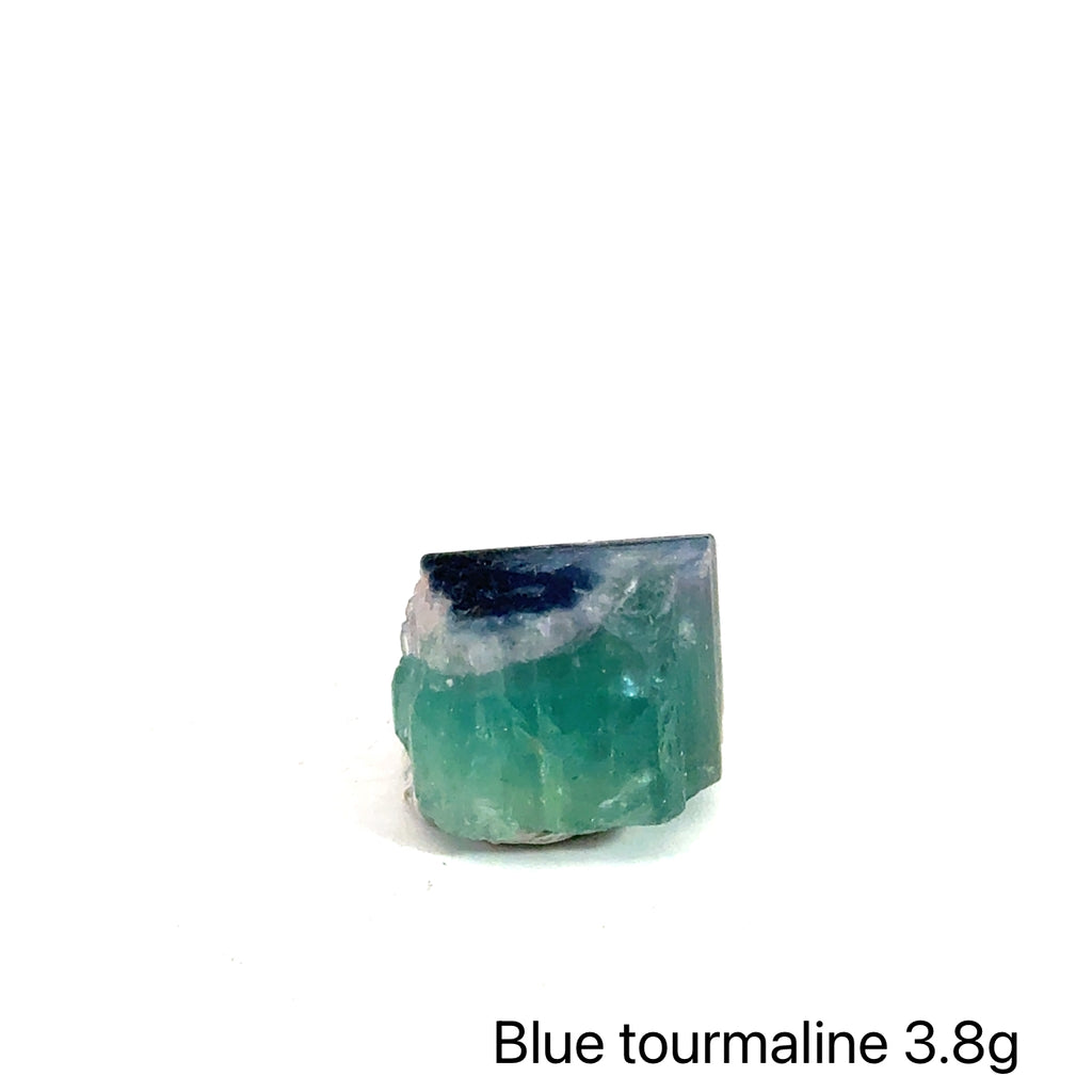 Genuine Blue Tourmaline Raw Gemstone on white 3.8g front view