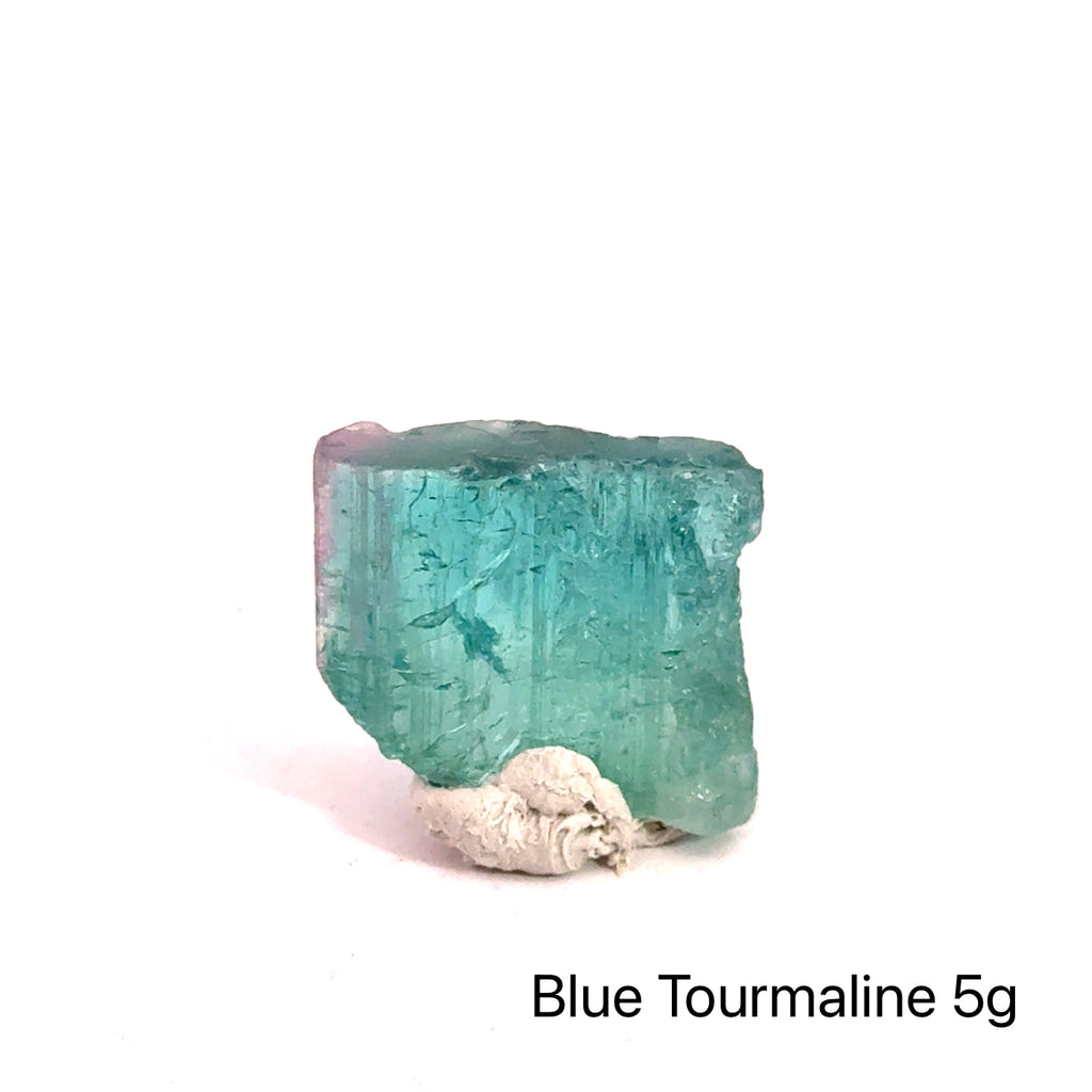 Genuine Blue Tourmaline Raw Gemstone on white 5g front view