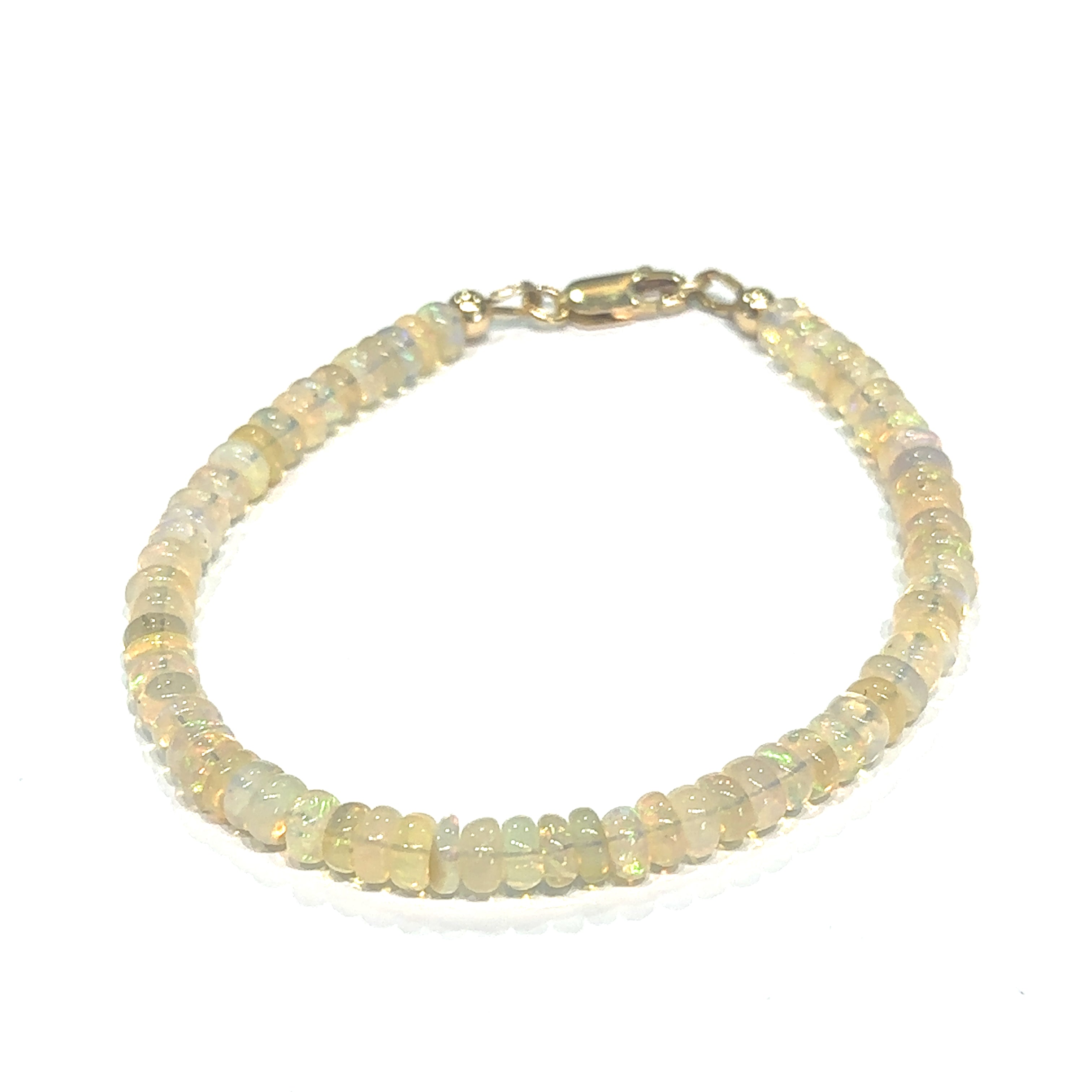 Genuine Ethiopian Opal gemstone bracelet with smooth roundel beads and gold‑filled lobster clasp on white center overview