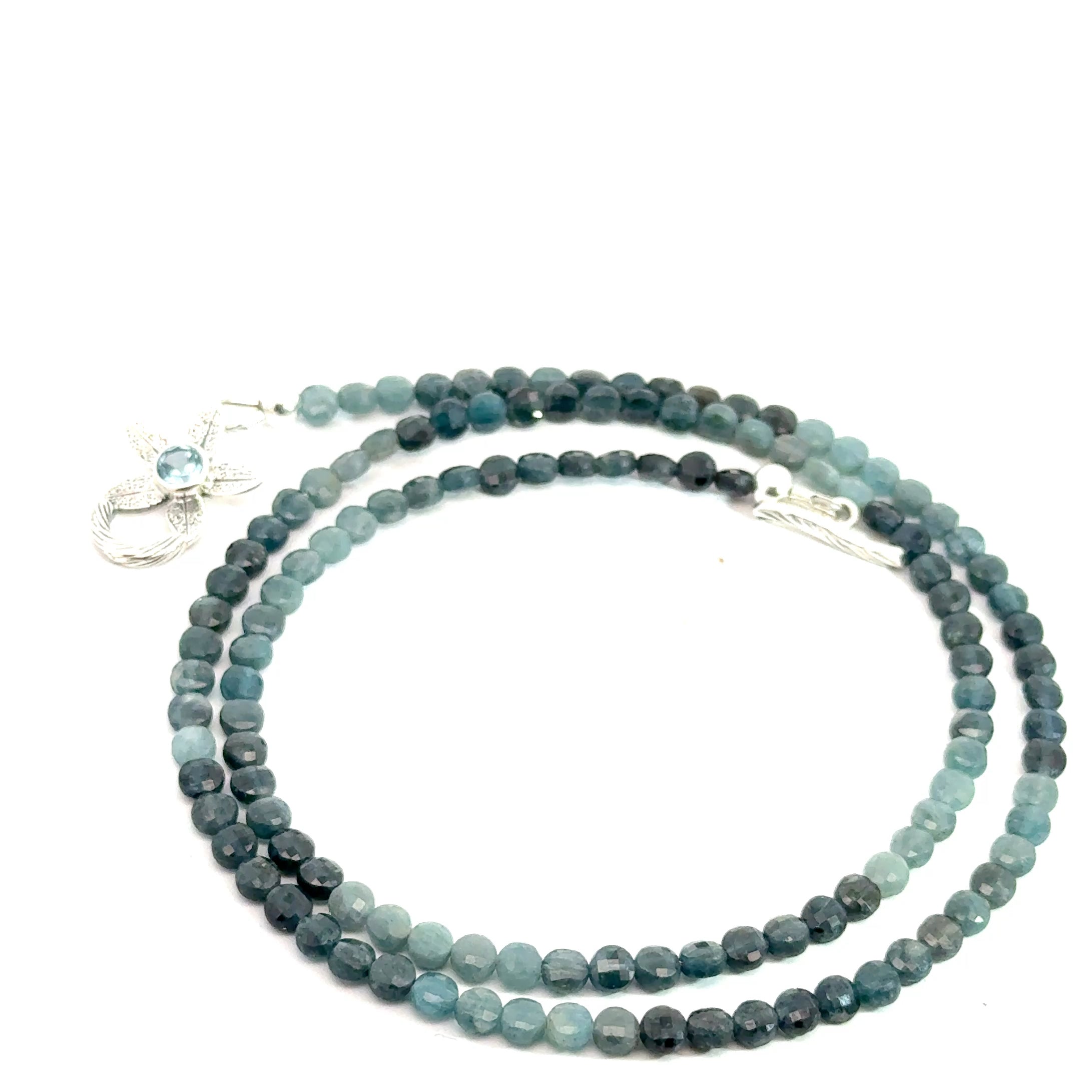 Genuine Grandidierite Gemstone Necklace on white up close up  spiral overview