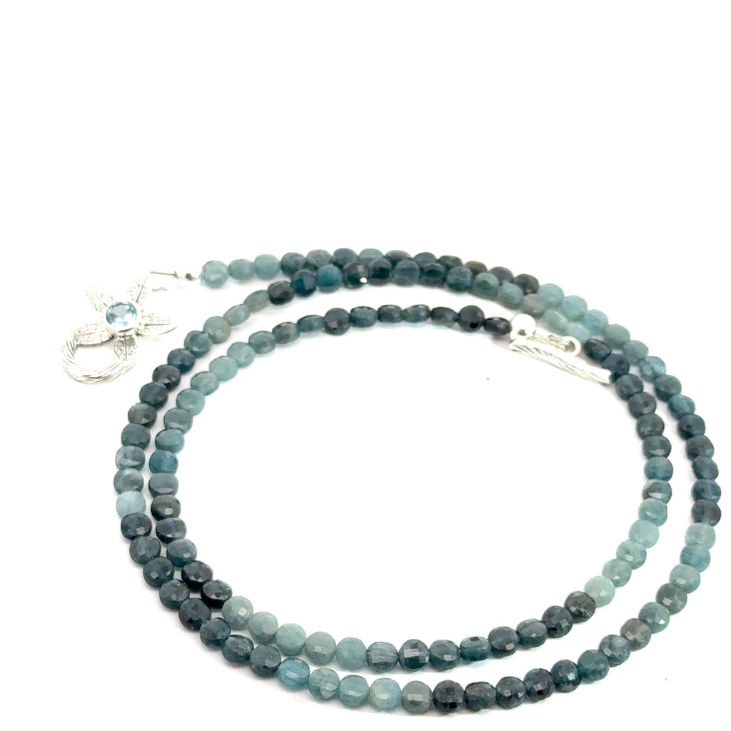 Genuine Grandidierite Gemstone Necklace on white up close up  spiral overview