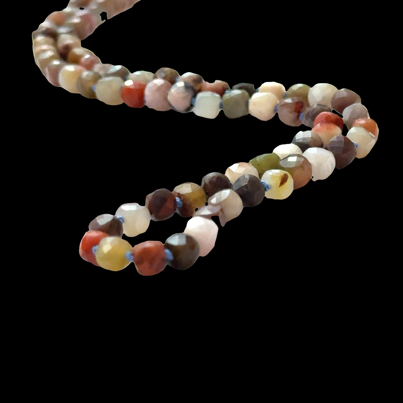  Genuine Petrified Wood beads showing natural grain patterns, fossilized wood necklace, earthy brown tones, on a black background, front close up overview.
