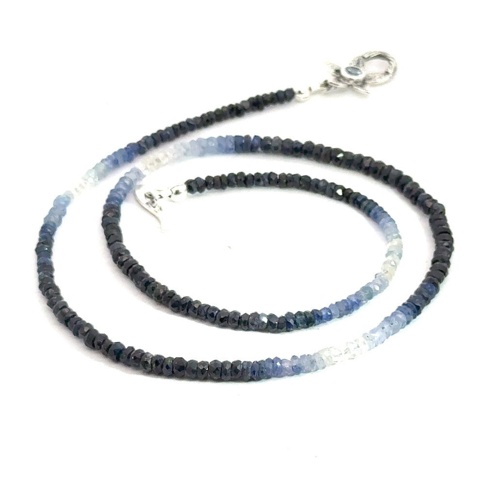 Genuine Sapphire gemstone necklace with a sterling silver toggle clasp by Hidden Jewel on a white background, center sprial front overview.
