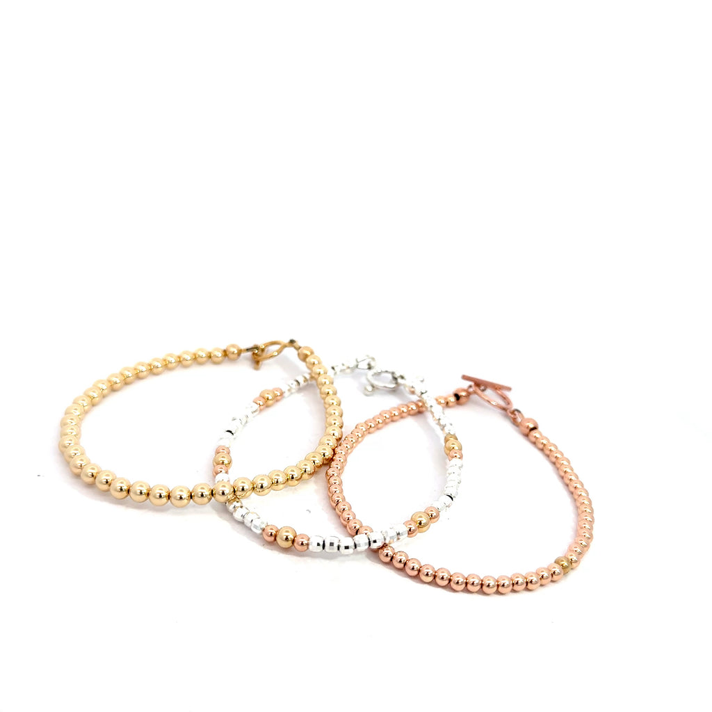 Gold, Rose Gold & Silver Faceted Bead Bracelet grouping on white front overview
