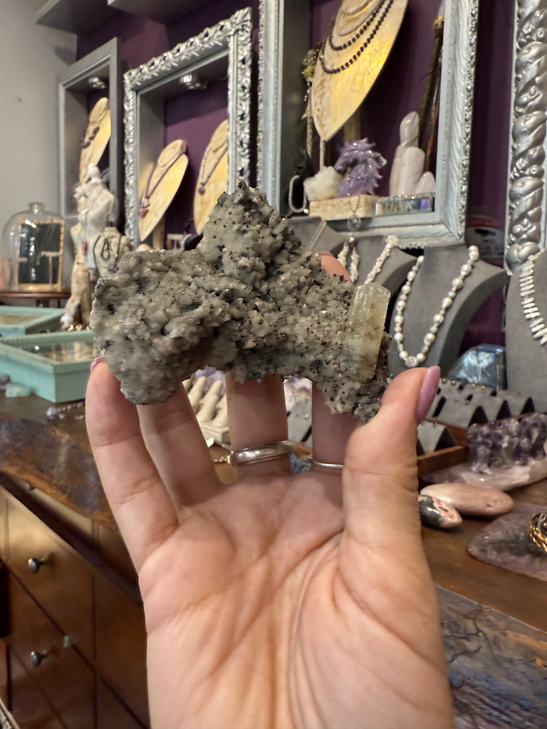 Golden Calcite on Dolomite with Chalcopyrite on store background in hand  close up view