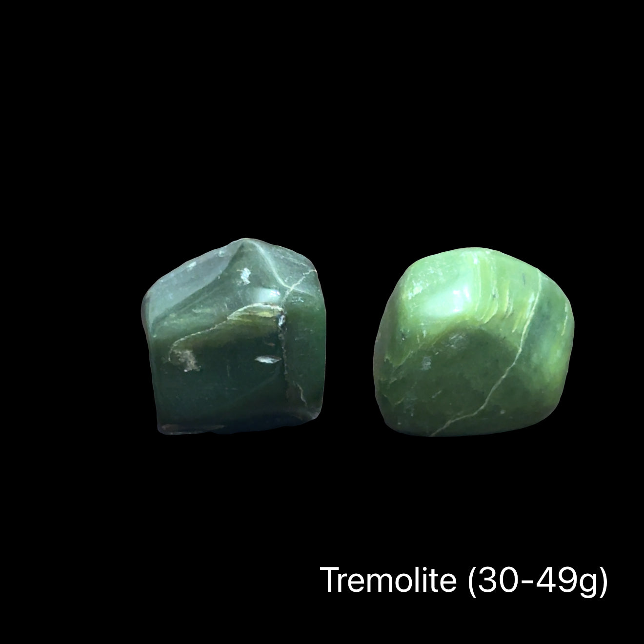 Green tremolite crystal on a black background with a weight of (30-49g), front view.