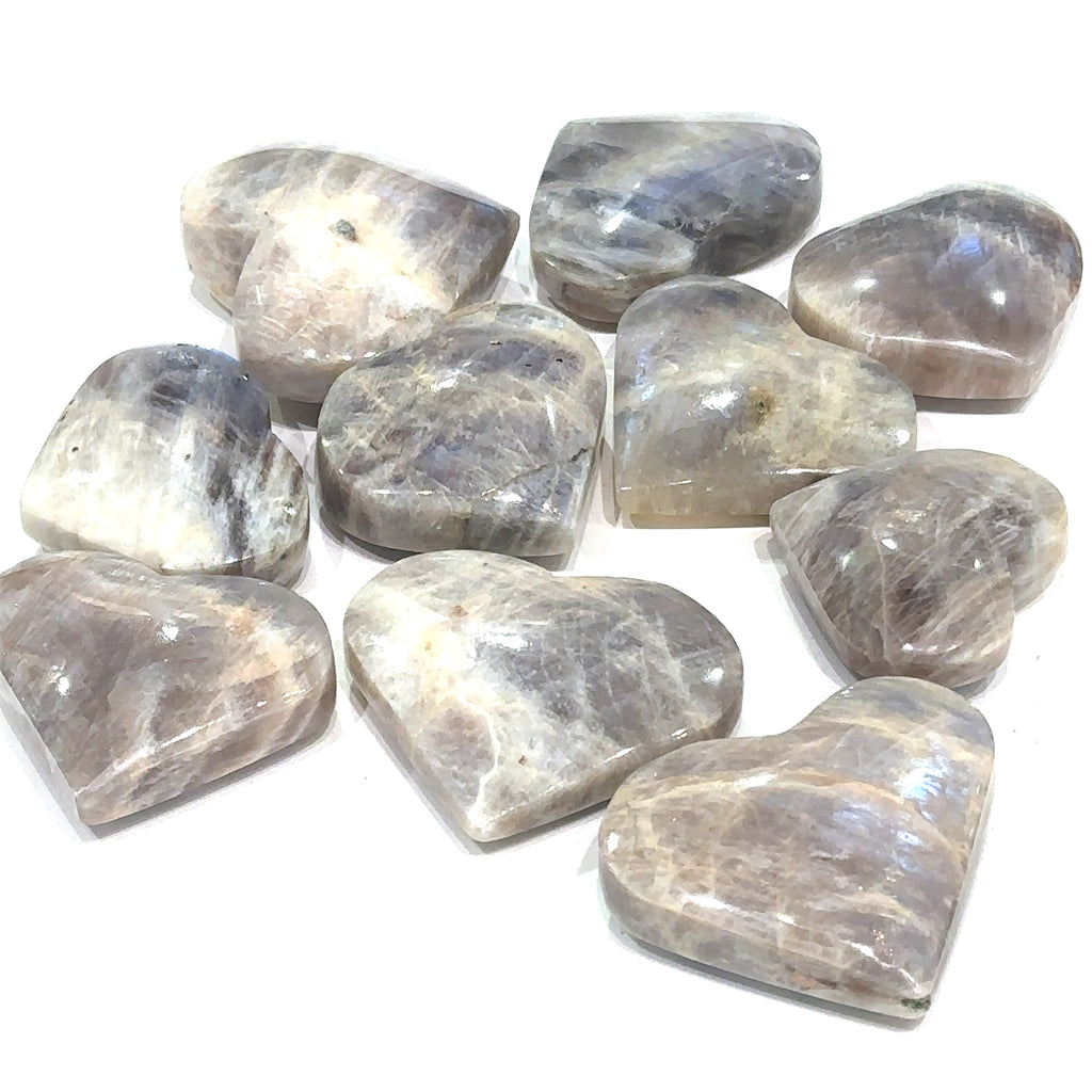Grey Moonstone gemstone heart for cleansing, protection, and emotional balance grouping on white overview