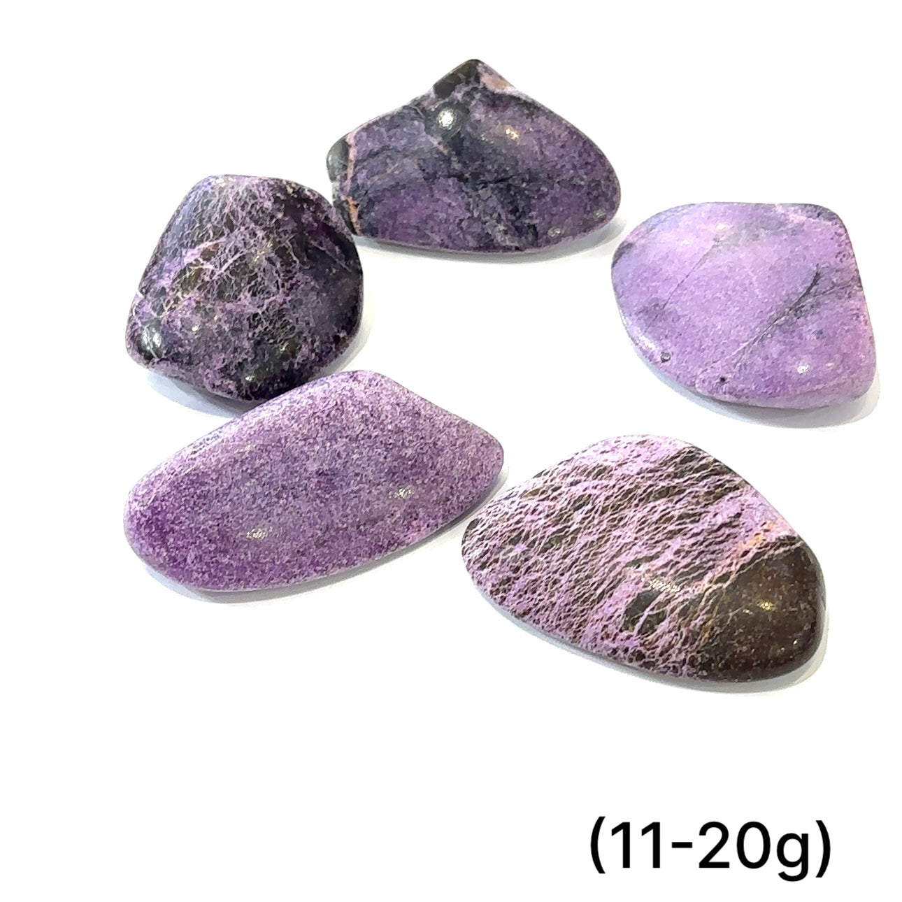 Group of Stichtite stones with calming purple hues representing emotional healing and transformation (11-20g) on white overview