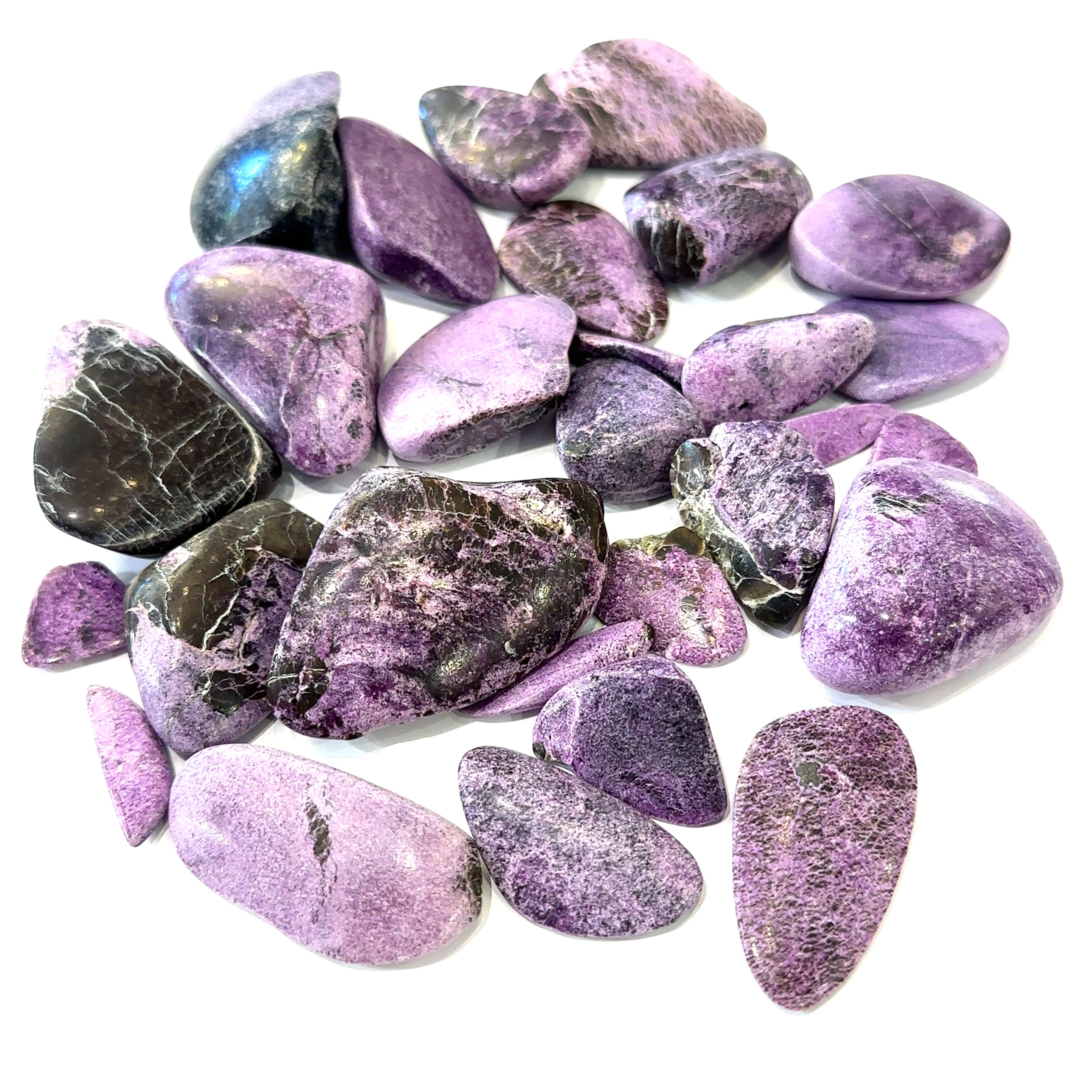 Group of Stichtite stones with calming purple hues representing emotional healing and transformation on white overview