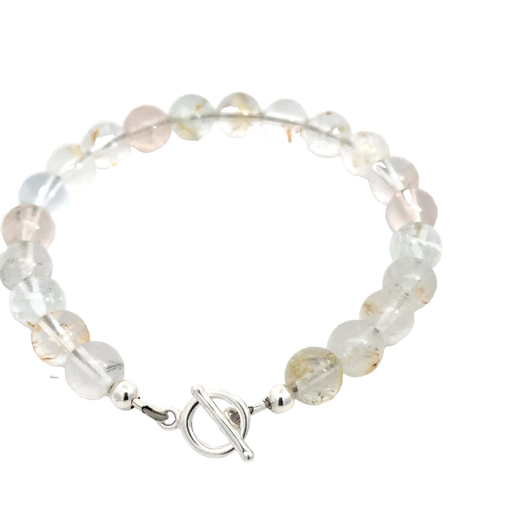 Hand‑crafted Blue Topaz bracelet with Beadlon wire and positive intentions on white backside overview