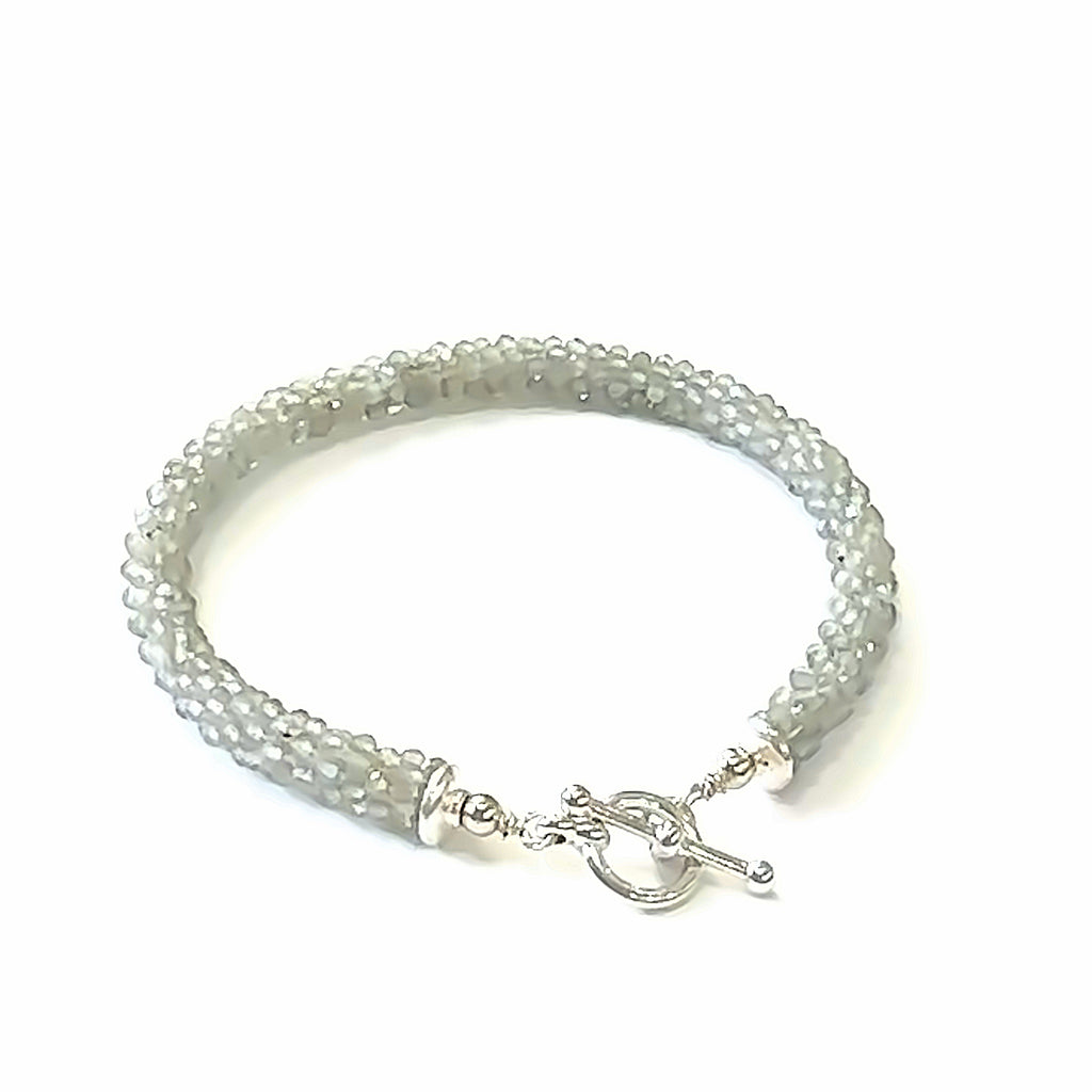 Handcrafted Labradorite gemstone bracelet with sterling silver toggle clasp on a white background, back toggle, close up overview. 