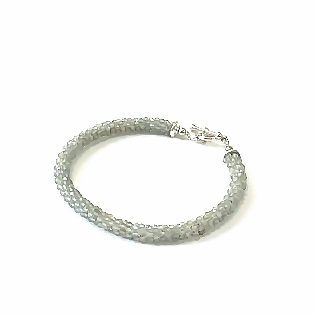 Handcrafted Labradorite gemstone bracelet with sterling silver toggle clasp on a white background, front, left angle, close-up overview. 