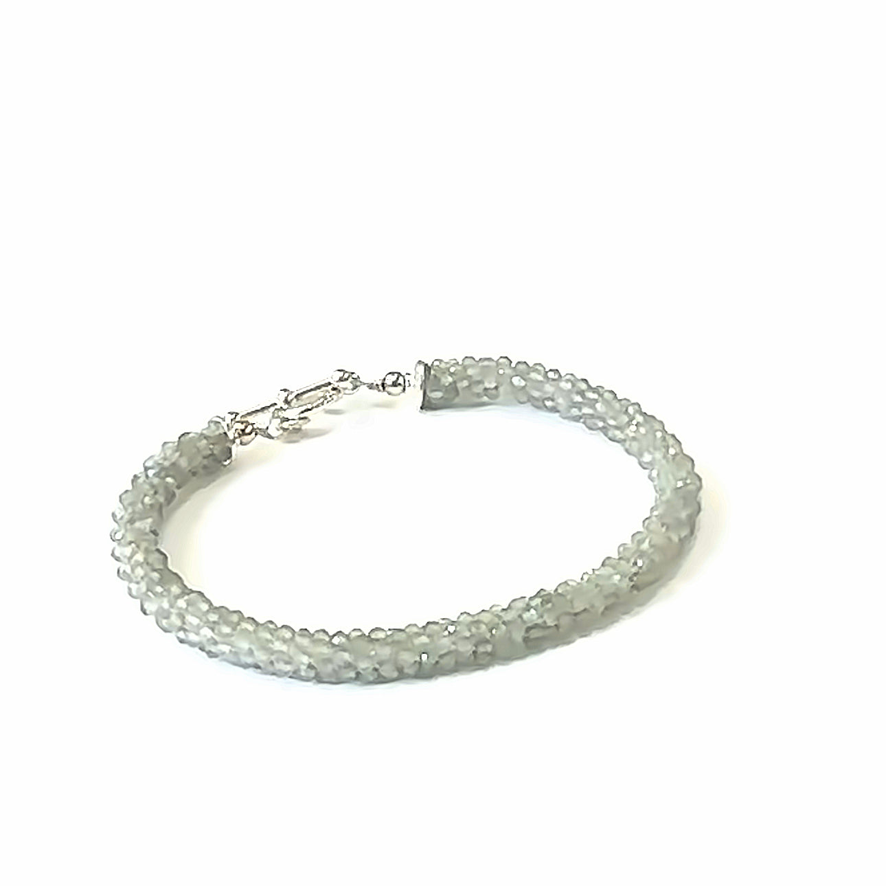 Handcrafted Labradorite gemstone bracelet with sterling silver toggle clasp on a white background, front left angle, close up overview. 
