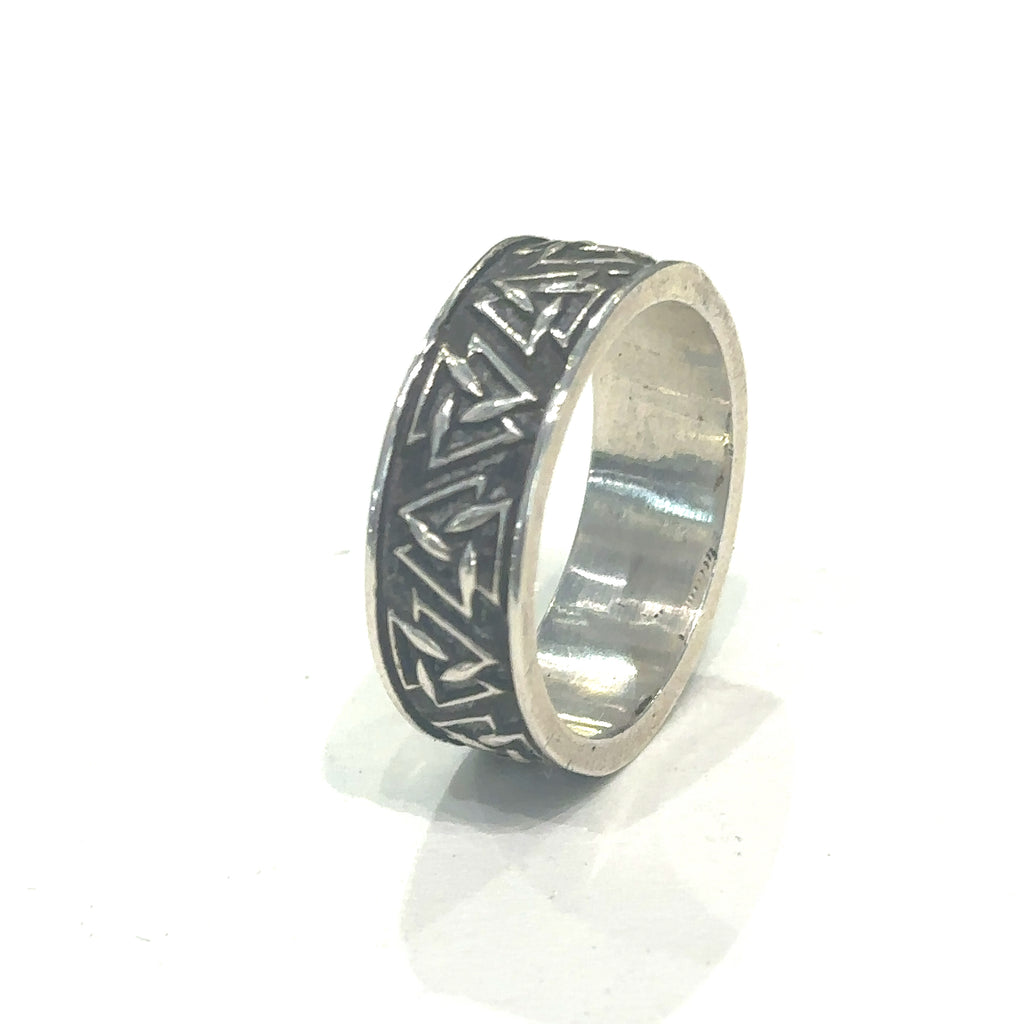 Handcrafted silver ring with continuous geometric triangle design on white long overview