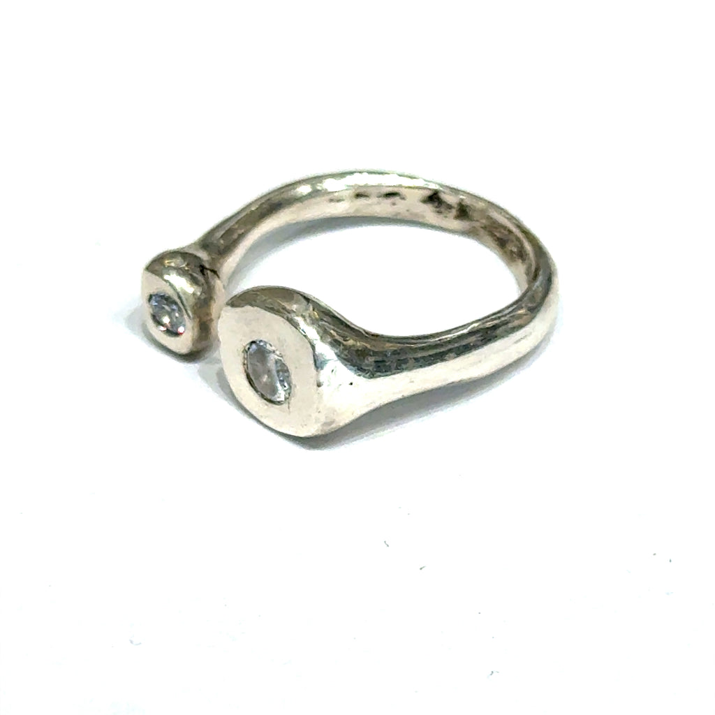Handcrafted sterling silver bubble ring with clear CZ accents — open shank design a close up view of the front left angle on a white background.