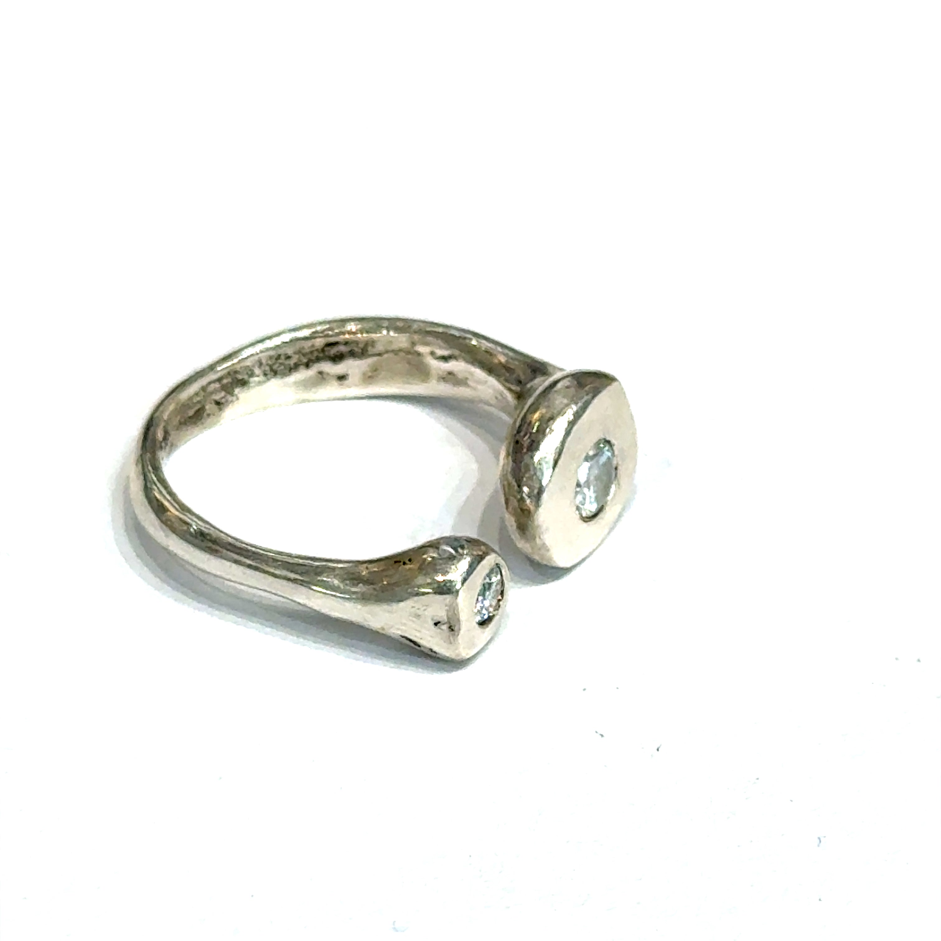 Handcrafted sterling silver bubble ring with clear CZ accents — open shank design a close up view of the front right angle on a white background.
