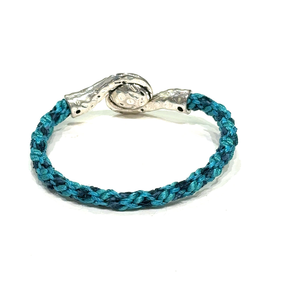 Handmade Kumihimo braided bracelet with silver clasp, featuring ribbon and satin cord deep blue on white back  view