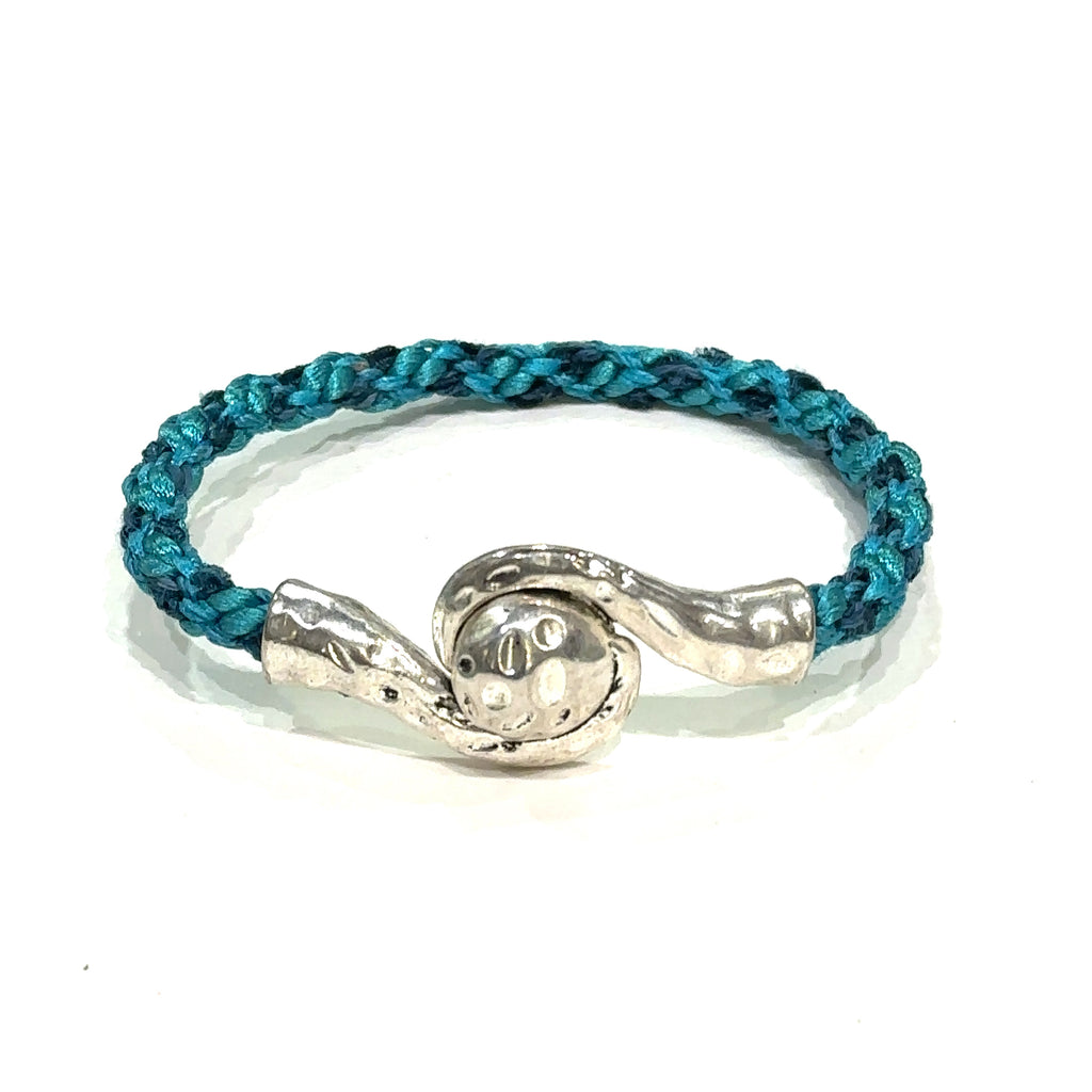 Handmade Kumihimo braided bracelet with silver clasp, featuring ribbon and satin cord deep blue on white front view
