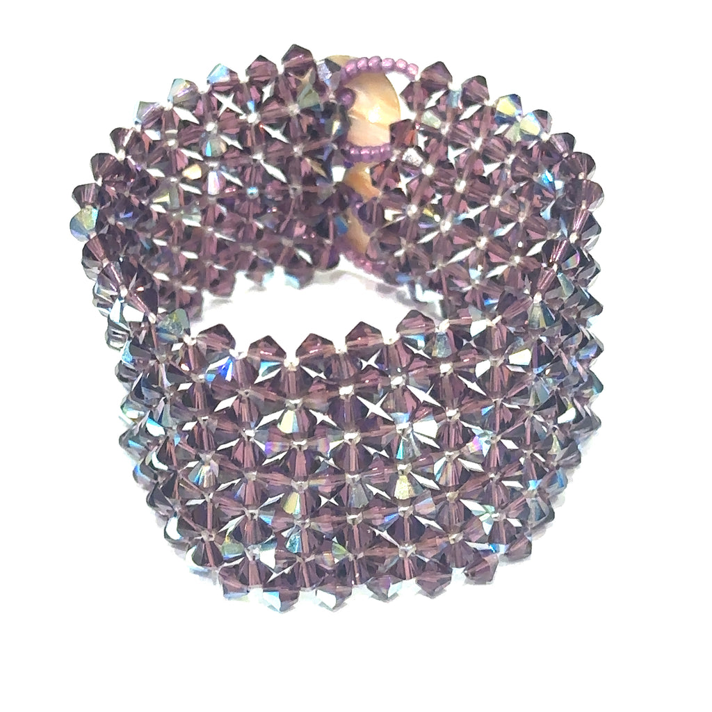 Handmade Purple Swarovski Crystal cuff bracelet with Abalone shell button clasp, 7.25'' long on white standing up cuff front view