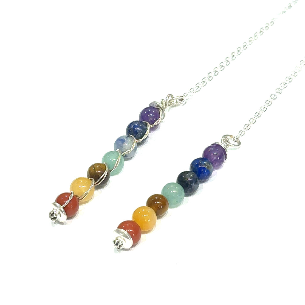 Handmade chakra gemstone beaded pendant necklace with sterling silver chain grouping on white long angled overview
