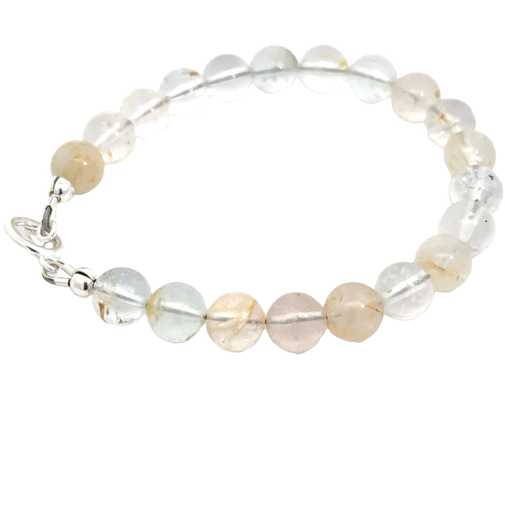 Healing Blue Topaz gemstone bracelet for throat and third eye chakra alignment on white side angle overview