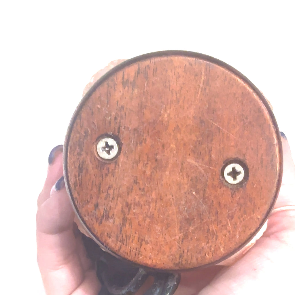 Healing Himalayan Salt lamp for home décor and spiritual cleansing on white in hand bottom view