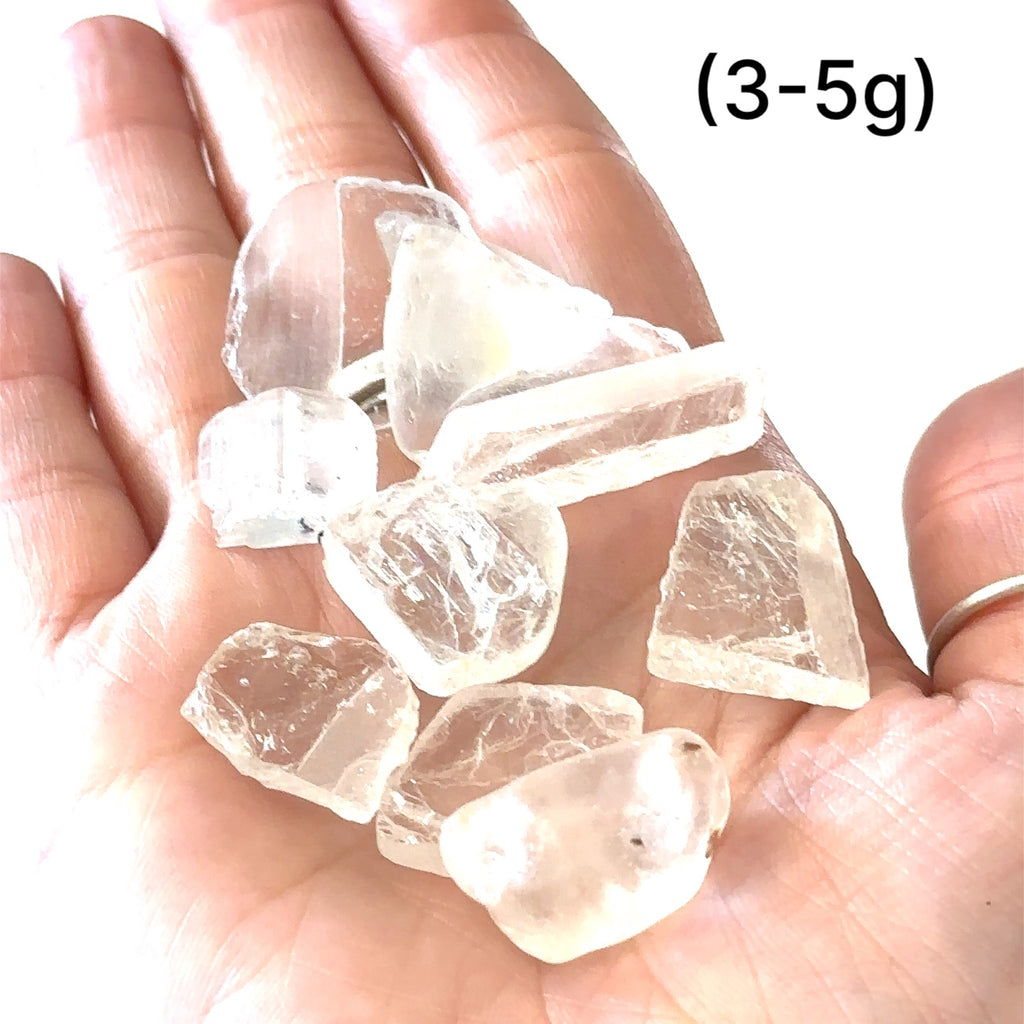 Healing White Topaz crystal for mental clarity, spirituality, and psychic gifts, grouping of gemstones (3-5g)  in hand to show a close-up overview
