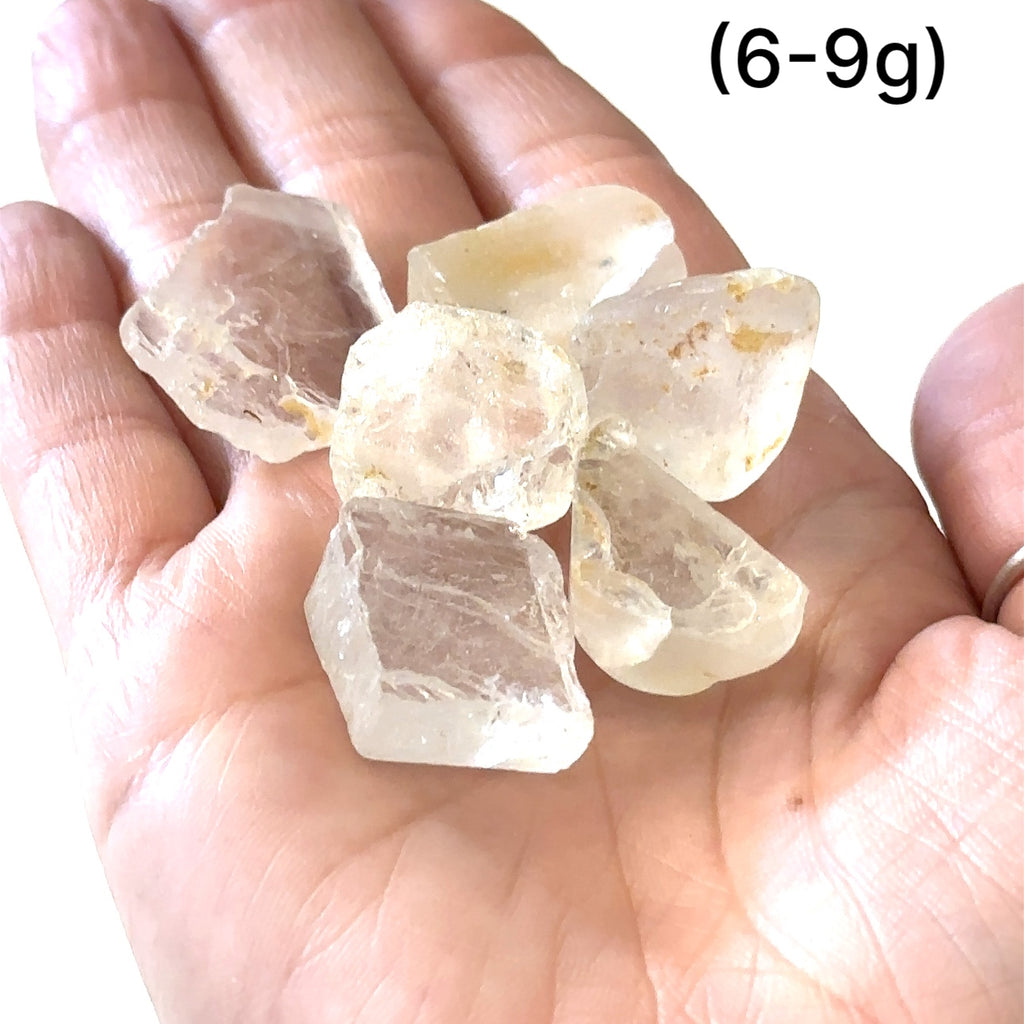 Healing White Topaz crystal for mental clarity, spirituality, and psychic gifts, grouping of gemstones (6-9g)  in hand to show a close-up overview