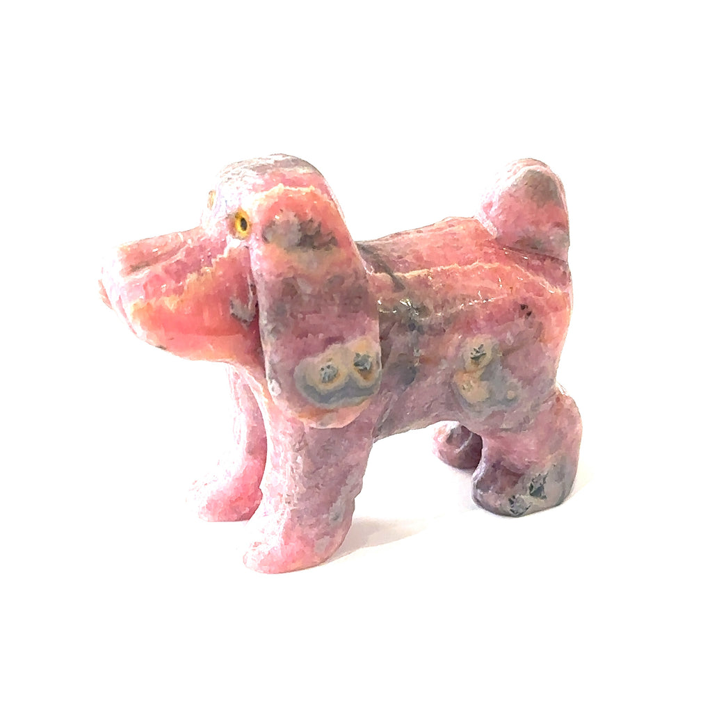 Healing crystal dog carving made from genuine rhodochrosite on white right side view