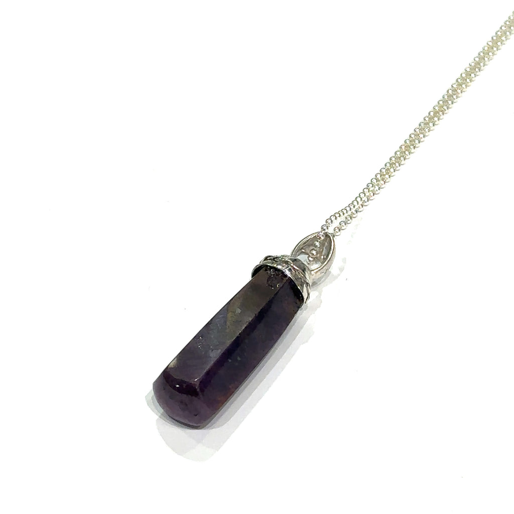 Healing ruby crystal necklace for passion, courage, and power on white left angled overview