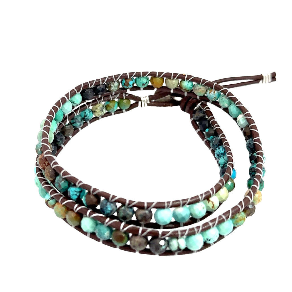 Healing turquoise crystal bracelet with adjustable double wrap leather band on white overview
