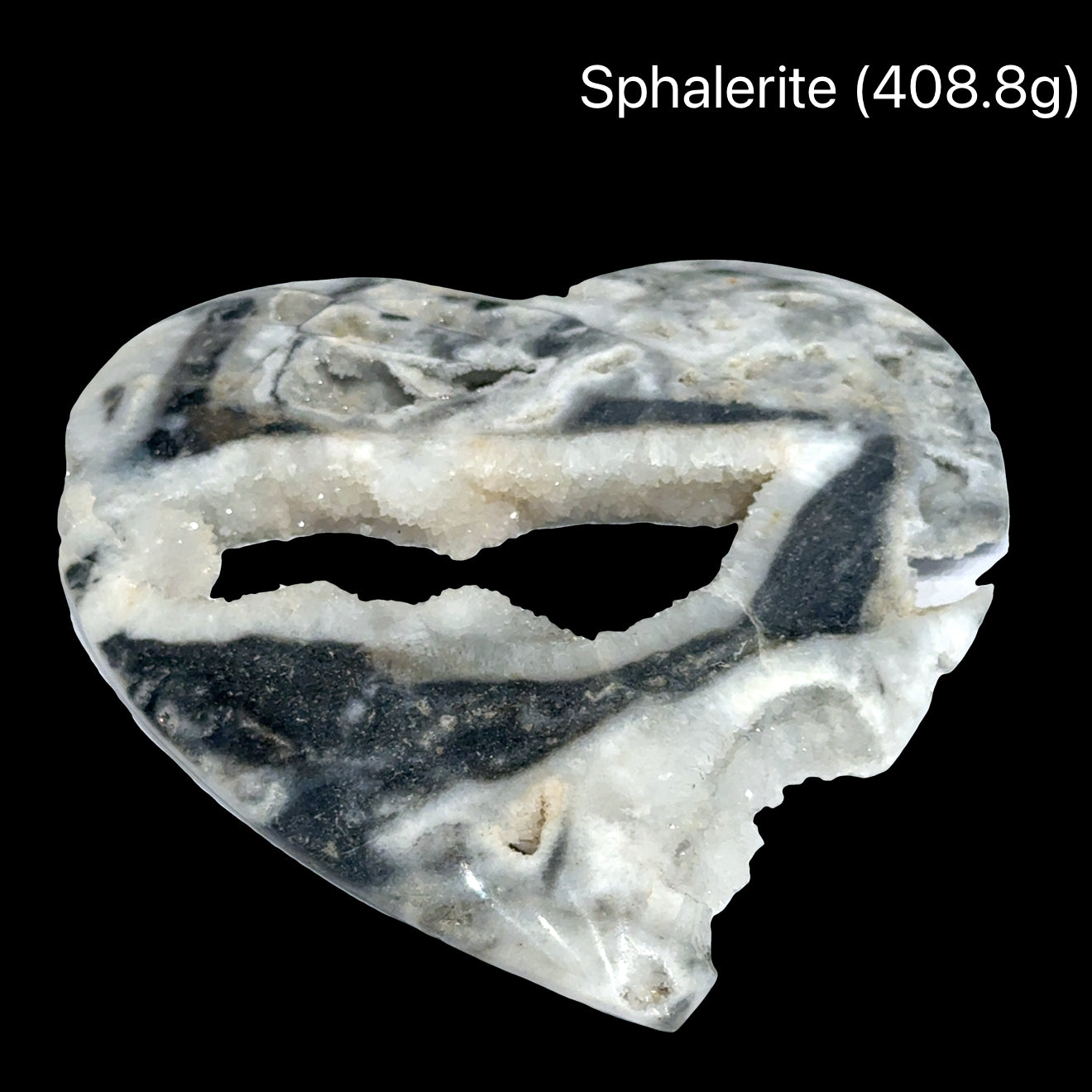 Heart-shaped sphalerite crystal on a black background with weight indication #A (408.8), front view.