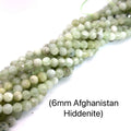 Hiddenite Gemstone Strand – 6mm Faceted Round Beads, 16" on white long overview