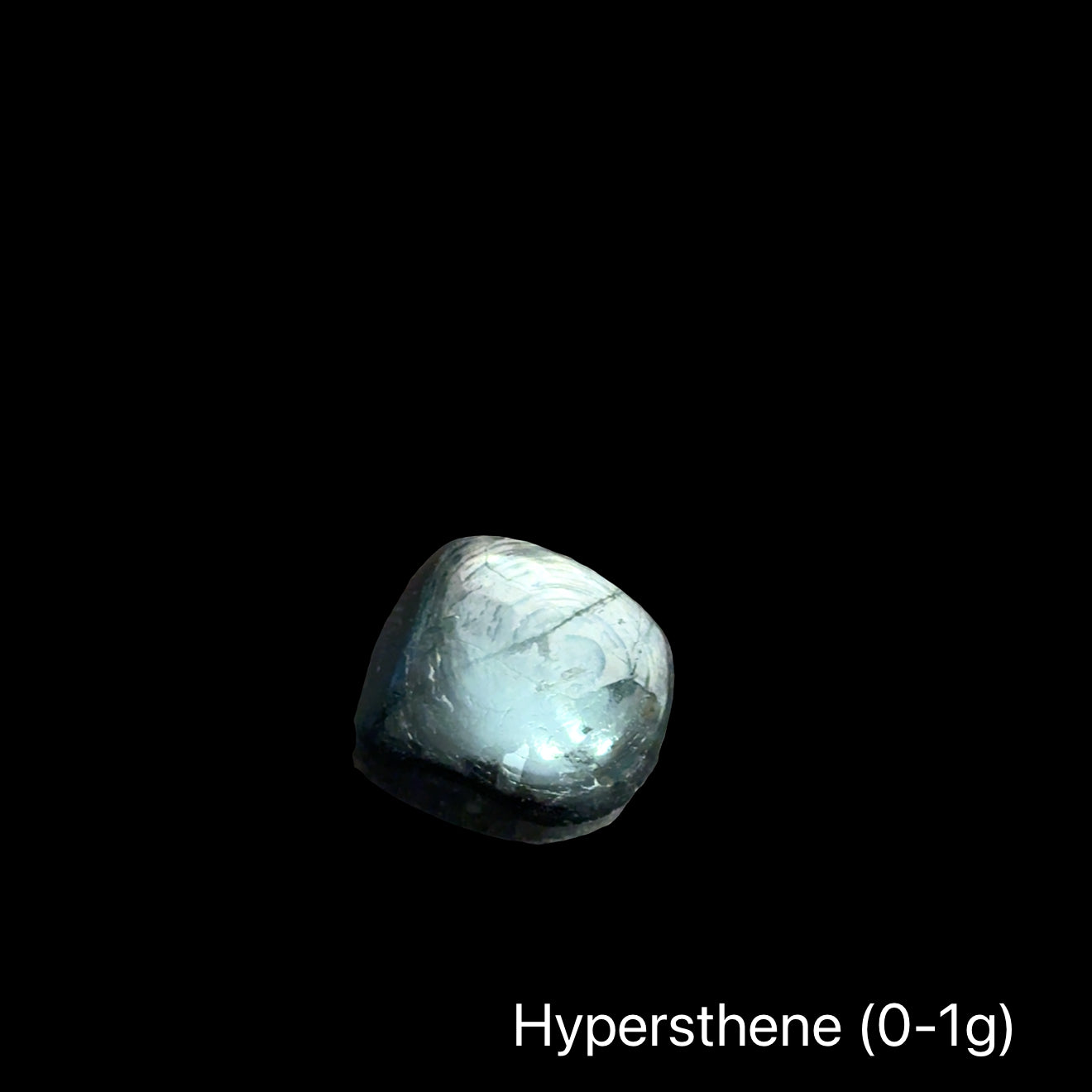 Hypersthene stone on a black background with the weight range indicated (0-10g), front view.