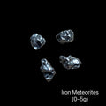 Iron meteorites on a black background with text indicating weight range (0-5g). front view.