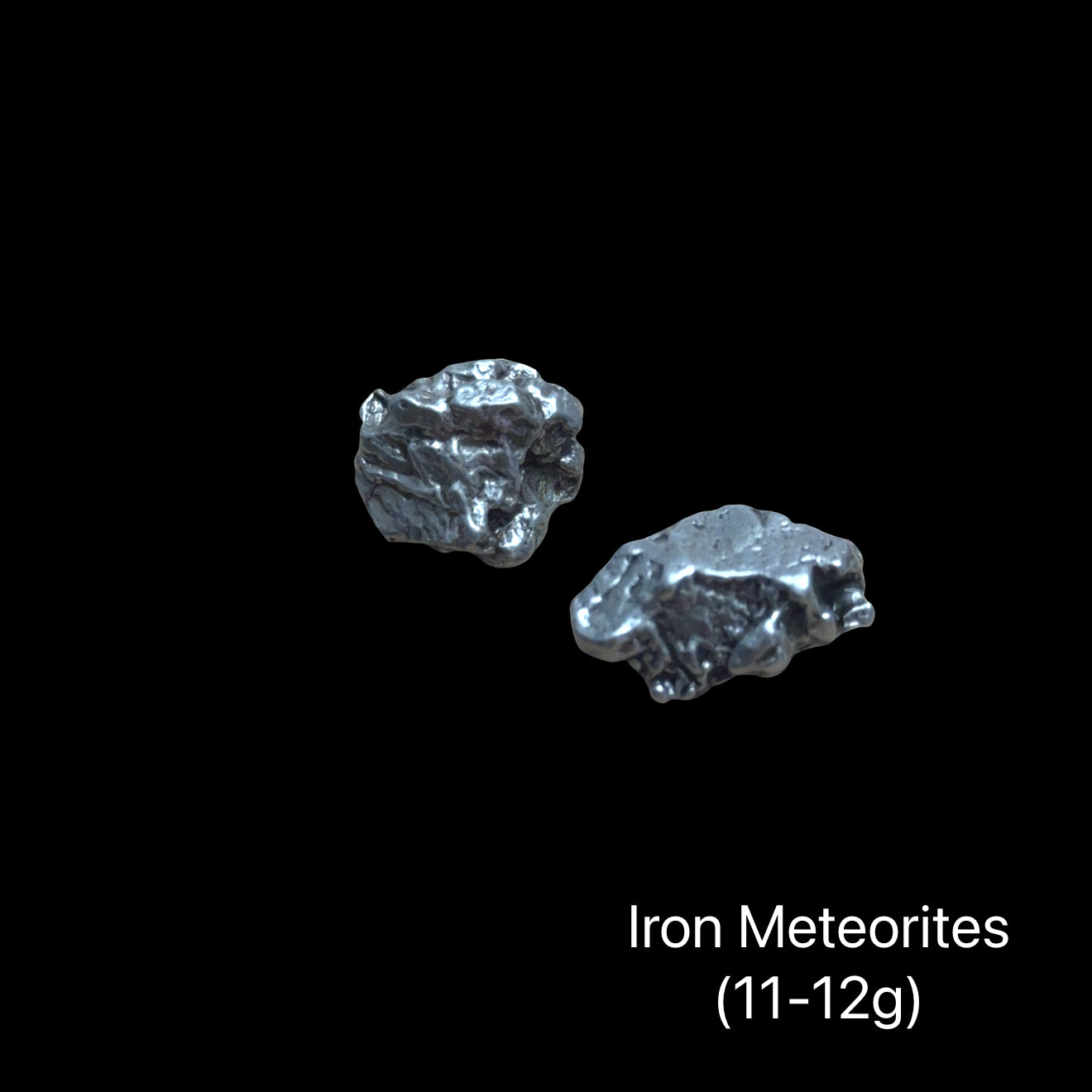 Iron meteorites on a black background with text indicating weight range (11-12g). front view.
