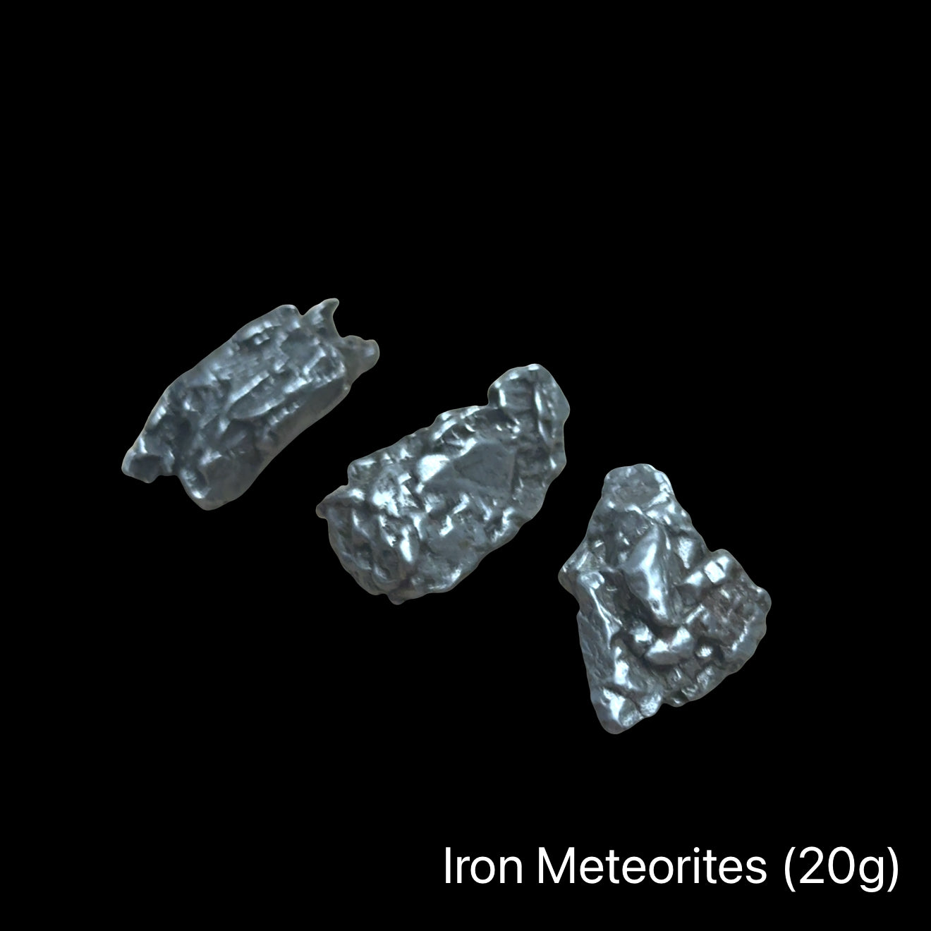 Iron meteorites on a black background with text indicating weight range (20g). front view.