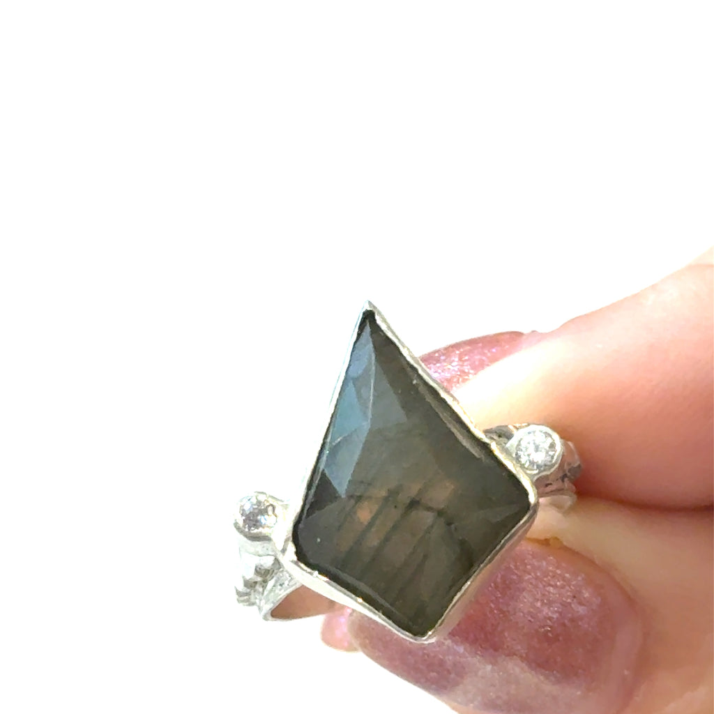 Labradorite Gemstone Ring on white in finger tip view