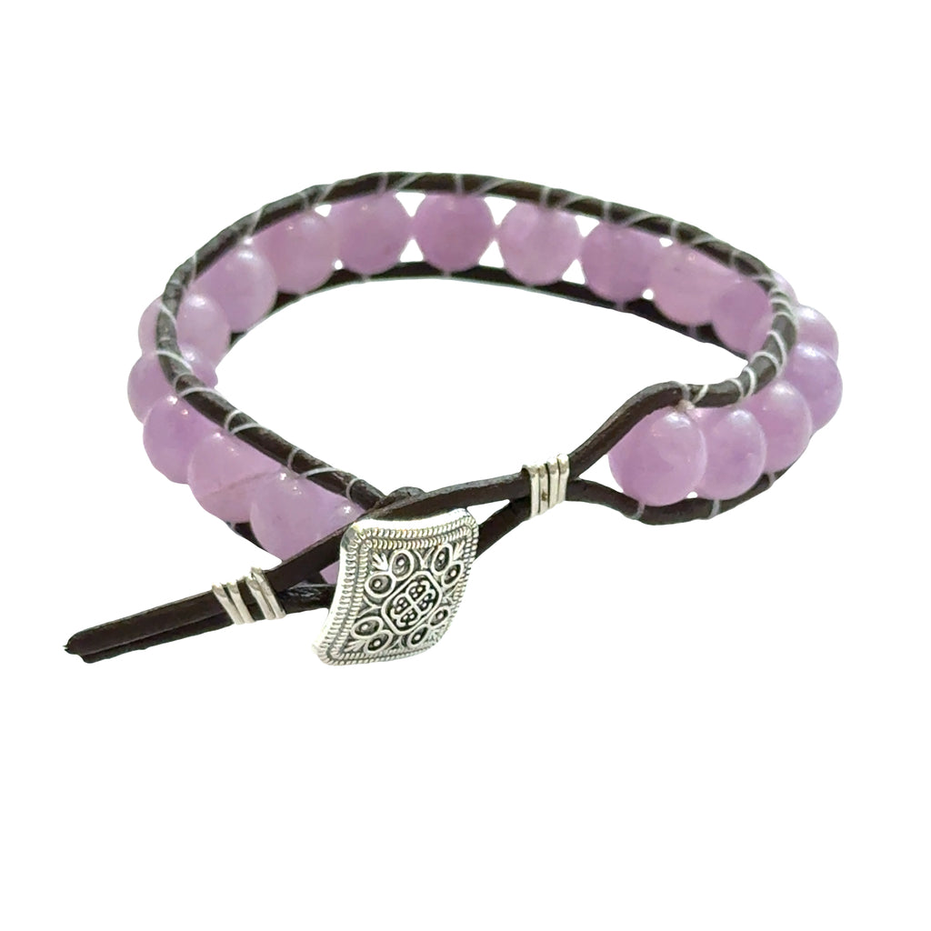 Lavender Jade leather wrap bracelet with 8mm purple beads on dark brown leather, silver decorative button, unisex spiritual jewelry, on a white background, back view.