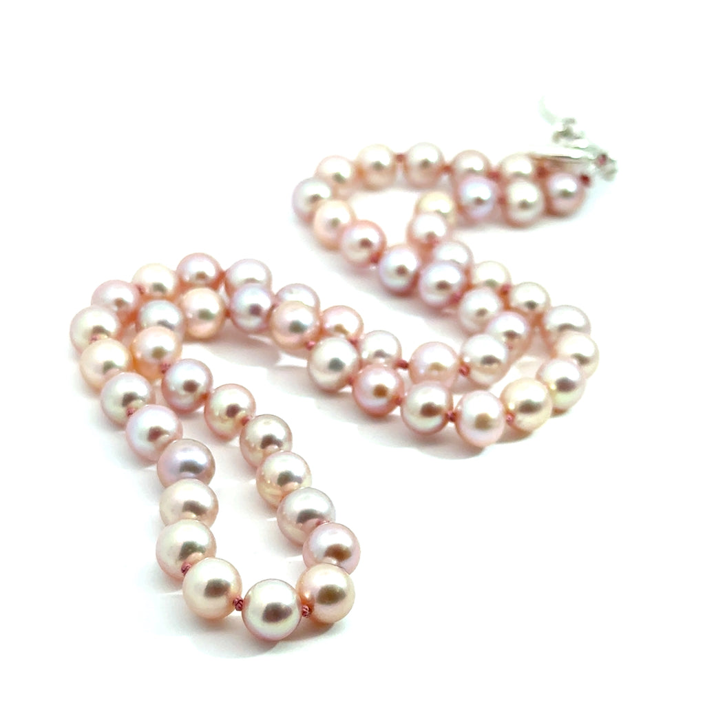 Light Pink Freshwater Pearl Necklace on white bottom close up overview